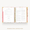 An open spiral-bound booklet with printed instructions and text pages, shown on a light gray background with the words 'INTRODUCTION & INSTRUCTIONS' below.