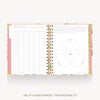An open spiral-bound workbook showing self-assessment worksheets with pink floral-patterned pages and gold-toned binding, centered on a light gray background with the text 'SELF-ASSESSMENT WORKSHEETS' below.