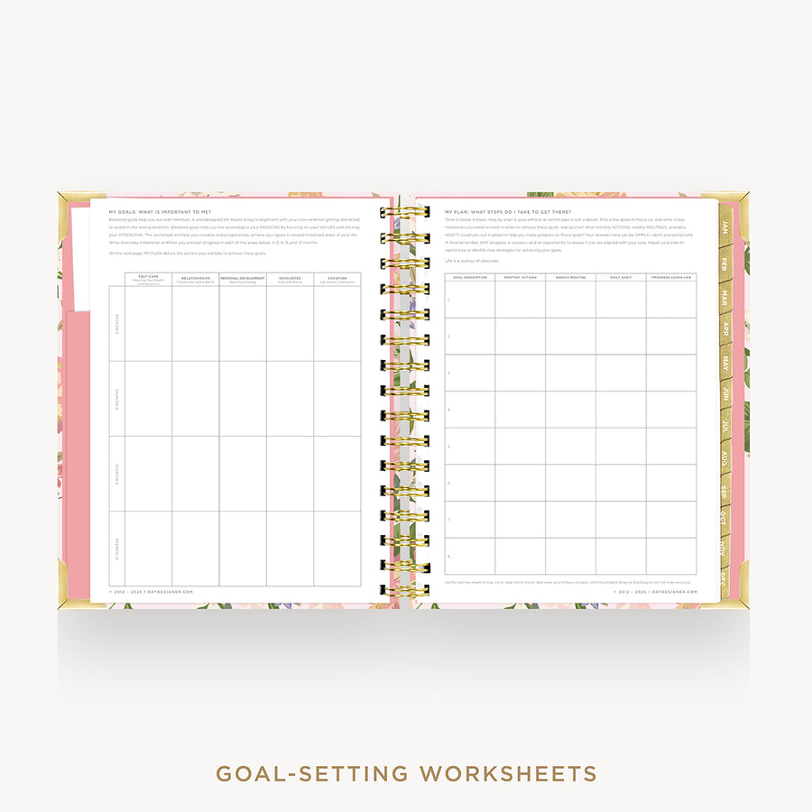 An open spiral-bound planner or notebook showing two printed goal-setting worksheet pages, with a pink floral cover and gold spiral binding on a light gray background. Text below reads 'GOAL-SETTING WORKSHEETS'.