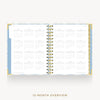 An open spiral-bound planner showing a 12-month overview calendar layout on white pages, with a light blue and pale yellow patterned cover and gold wire binding, centered on a light gray background with the text '12-MONTH OVERVIEW' below.