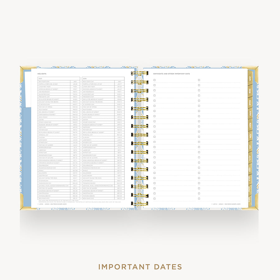 An open spiral-bound planner or agenda showing a monthly calendar layout and lined daily pages, with a light blue and white patterned cover and gold-toned rings, on a light gray background. The words 'IMPORTANT DATES' appear below.