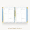 An open spiral-bound planner or notebook showing two printed checklist pages titled 'ENTERTAINMENT CHECKLIST.' The pages are white with gray lines and tables, bordered by a pale blue patterned cover and gold-toned spiral binding.