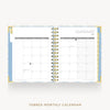 An open spiral-bound tabbed monthly calendar showing January 2027, with white pages, light blue and yellow patterned tabs, and gold wire binding, centered on a light gray background with the text 'TABBED MONTHLY CALENDAR' below.
