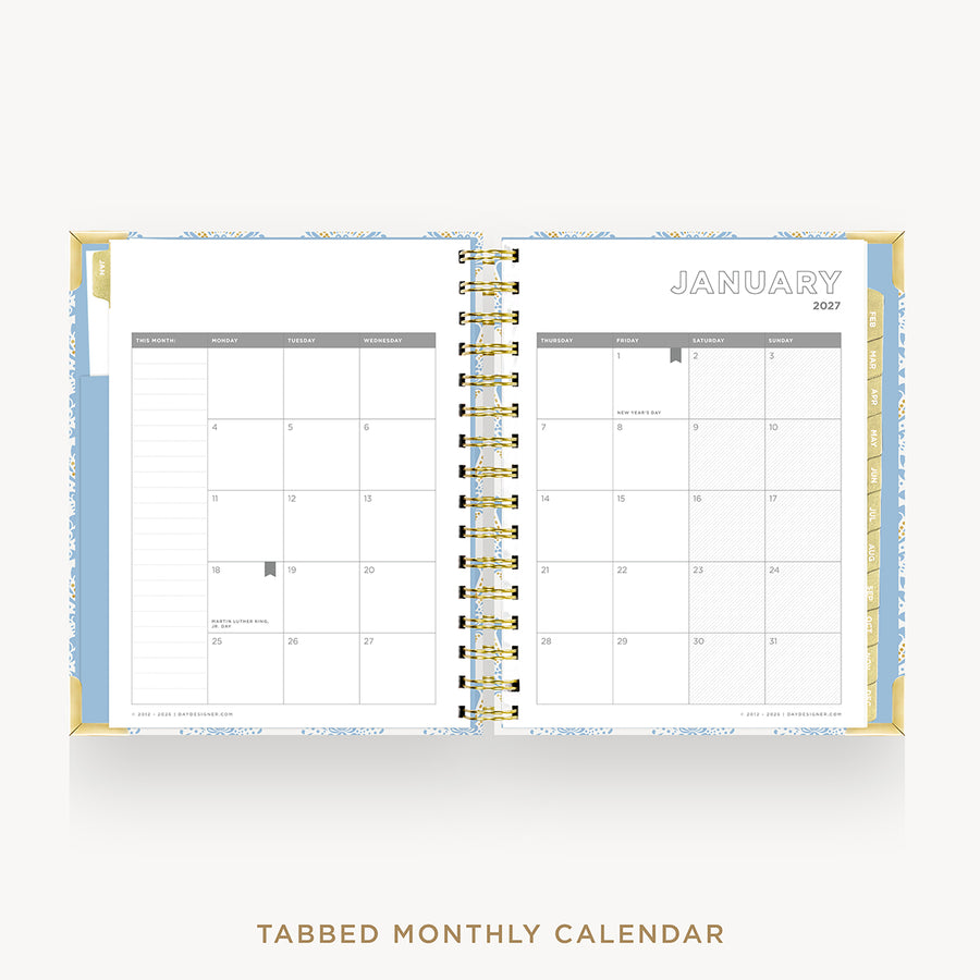 An open spiral-bound tabbed monthly calendar showing January 2027, with white pages, light blue and yellow patterned tabs, and gold wire binding, centered on a light gray background with the text 'TABBED MONTHLY CALENDAR' below.