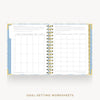 An open spiral-bound planner or workbook showing two pages of goal-setting worksheets, with a gold wire binding and a light blue and white patterned cover, on a light gray background. Text below reads 'GOAL-SETTING WORKSHEETS'.