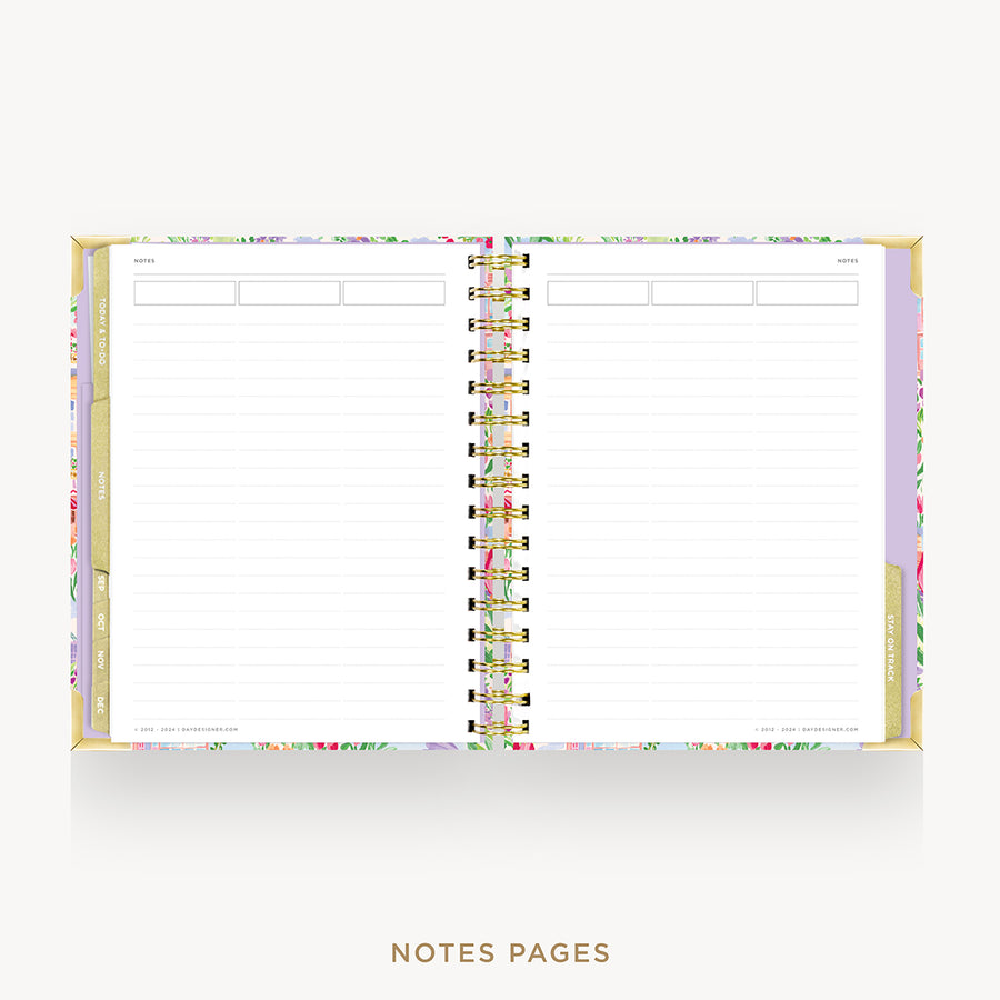 An open spiral-bound planner or notebook showing lined notes pages, with a pastel floral patterned cover and gold-toned binding, on a light gray background. The text 'NOTES PAGES' appears below.
