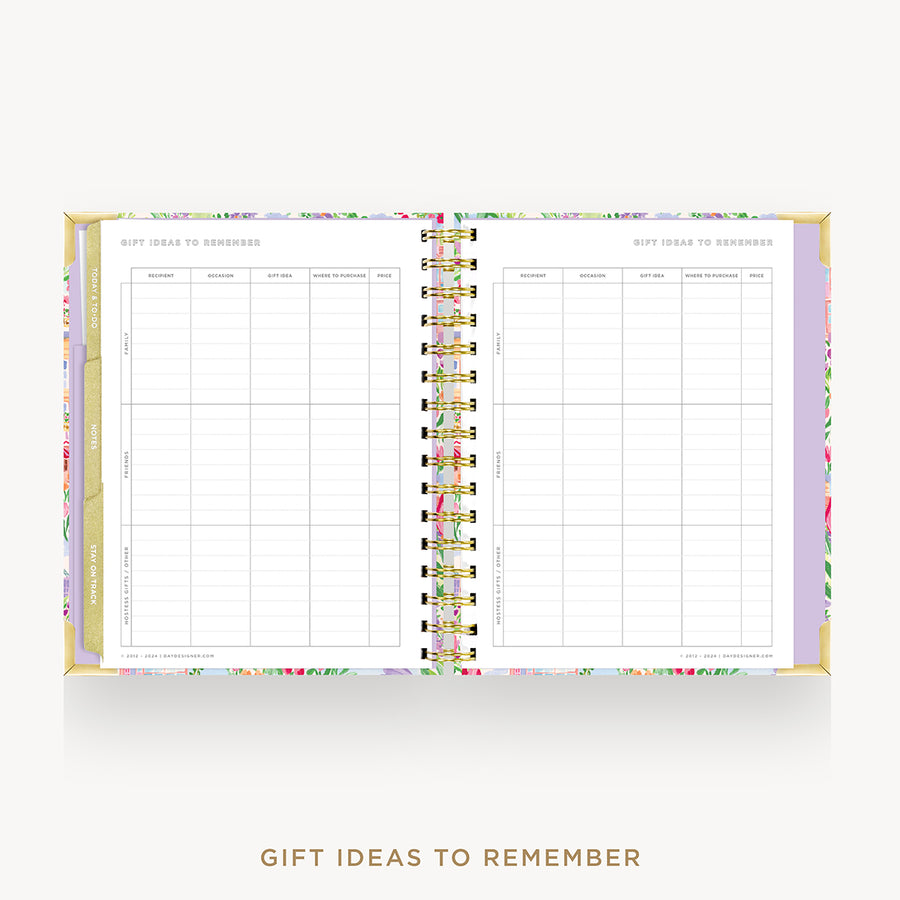 An open spiral-bound gift planner or memo book with floral-patterned covers and white pages titled 'GIFT IDEAS TO REMEMBER,' shown on a light gray background with matching text below.