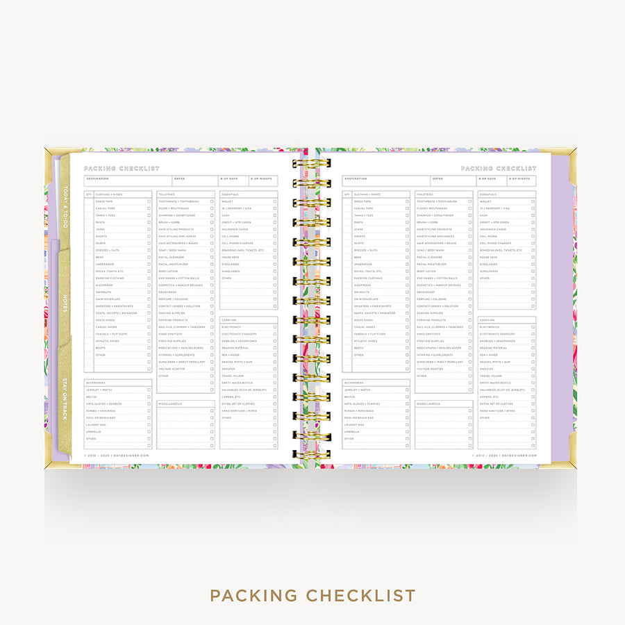An open spiral-bound planner or notebook showing a packing checklist page, with a pastel floral border and gold-toned rings on a light gray background. The text 'PACKING CHECKLIST' appears below.