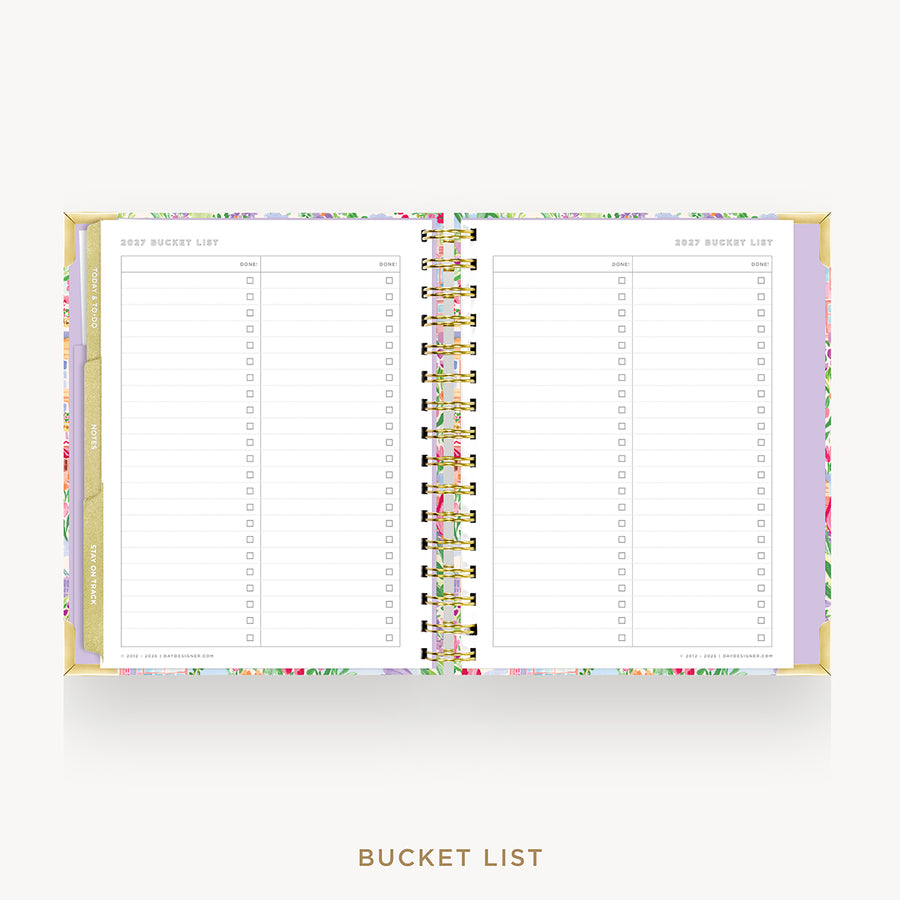 An open spiral-bound bucket list planner on a light gray background. The planner has a pastel floral border and gold-toned rings, with lined pages titled 'BEST BUCKET LIST' on both sides.