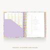 An open spiral-bound planner shown from above on a white background, with a floral-patterned cover, gold-toned ring binder, lavender pocket, and printed inserts. Text below reads 'POCKET, STICKERS AND RULER'.