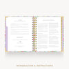 An open spiral-bound booklet with floral-patterned edges and printed introduction and instructions pages, shown on a light gray background with the text 'INTRODUCTION & INSTRUCTIONS' below.