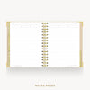 An open spiral-bound planner or notebook with white lined pages, gold binding, and gold page edges, shown on a light gray background with the text 'NOTES PAGES' below.