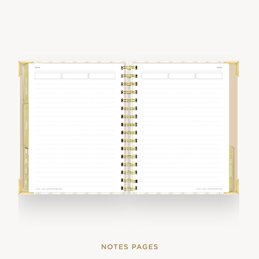 An open spiral-bound planner or notebook with white lined pages, gold binding, and gold page edges, shown on a light gray background with the text 'NOTES PAGES' below.