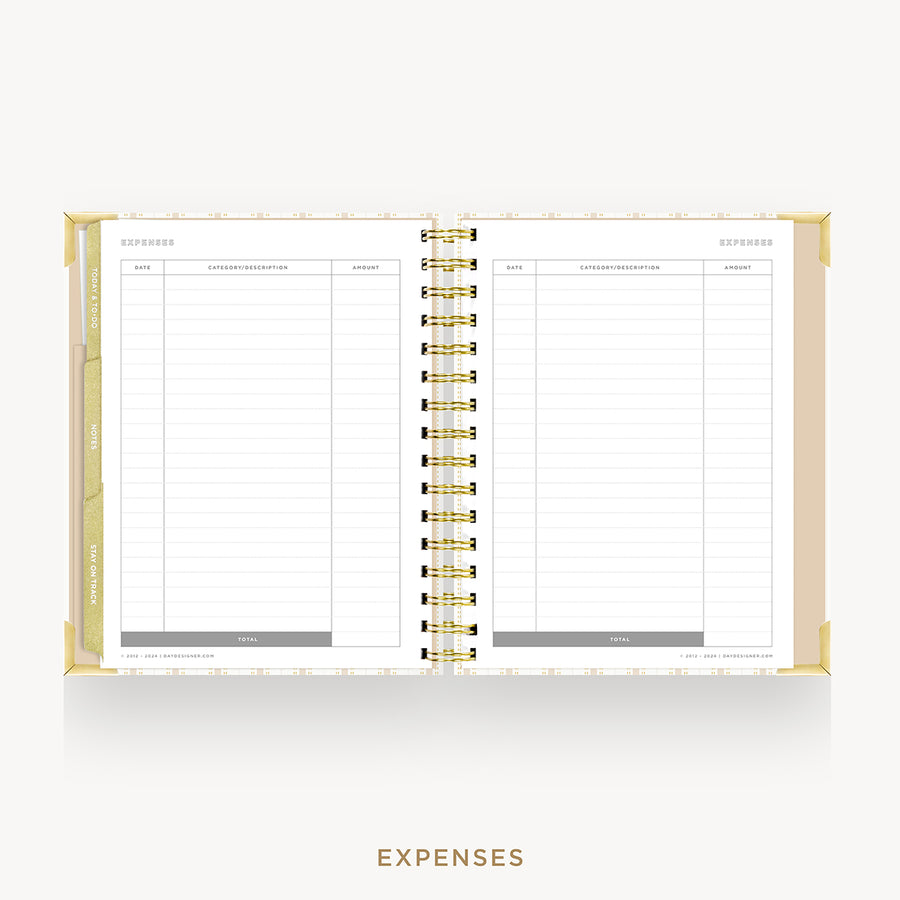 An open spiral-bound planner or notebook showing two blank expense pages with gold rings and a gold cover edge, centered on a light gray background with the word EXPENSES below.