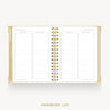 An open spiral-bound planner or notebook showing a favorites list page layout with lined sections and checkboxes, photographed on a light gray background with the words 'FAVORITES LIST' below.