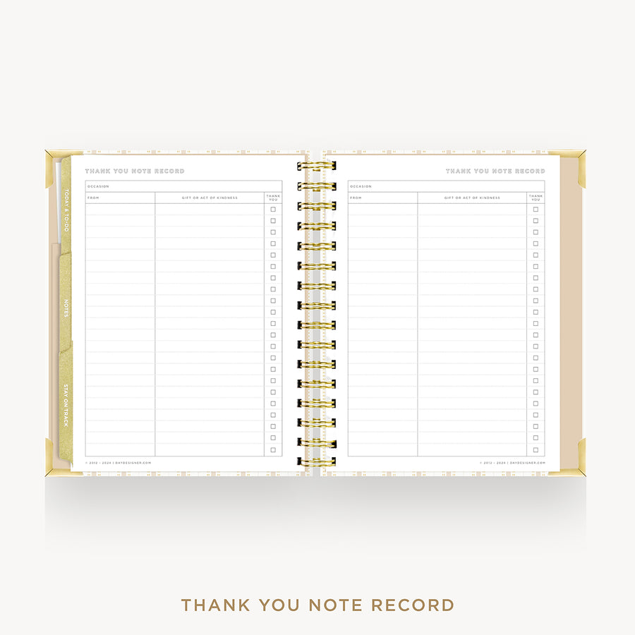 An open spiral-bound thank you note record planner on a light gray background, with gold-toned binding and lined pages visible. The text 'THANK YOU NOTE RECORD' appears below the product.