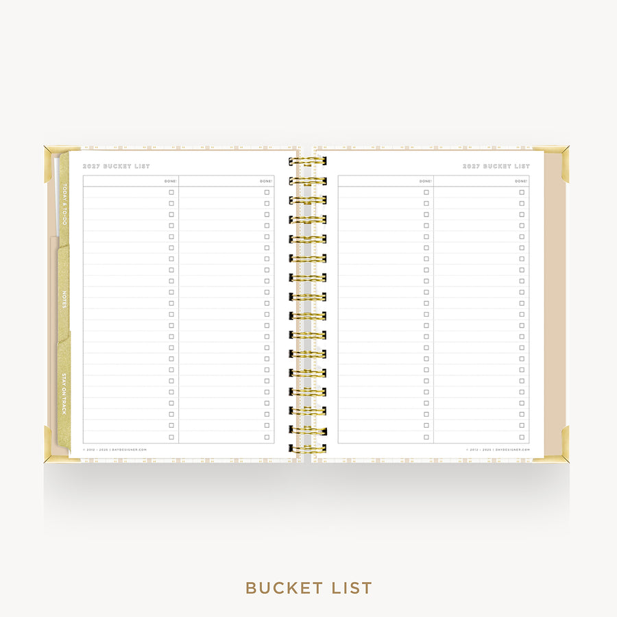 An open spiral-bound planner or notebook showing a 'Bucket List' page layout with lined sections and checkboxes, photographed on a clean white background with the words 'BUCKET LIST' below.