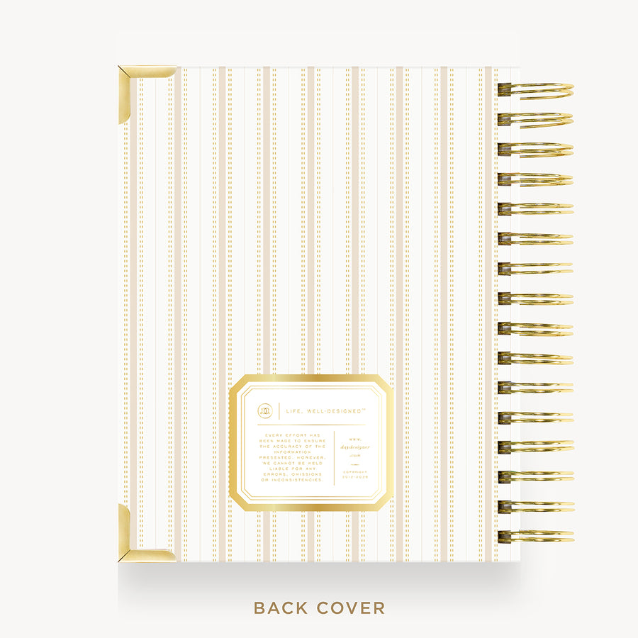 A spiral-bound notebook shown from the back cover, featuring vertical cream and gold stripes, gold corner accents, and a gold-bordered label area. The text 'BACK COVER' appears below on a light gray background.