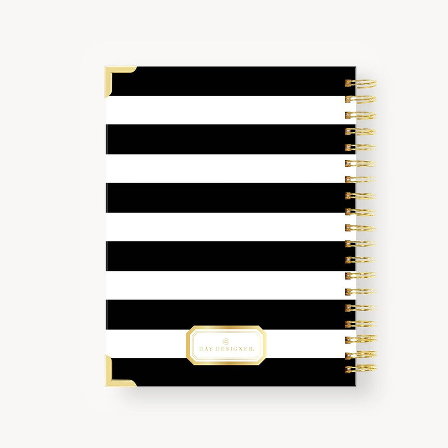 Black and white striped notebook with gold accents on a white background