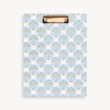 Clipboard with blue shell pattern on a white background