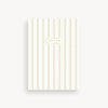 Notebook with gold stripes and 'Notes' label on a white background