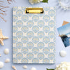 Clipboard with shell pattern on a light blue background with decorative elements.