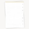 White notebook with dot grid on a white background