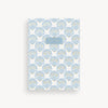 Notebook with blue shell pattern on a white background