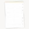 White notebook with grid pattern on a white background