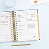 Day Designer 2026 mini daily planner: navy bookcloth opened with writing on it