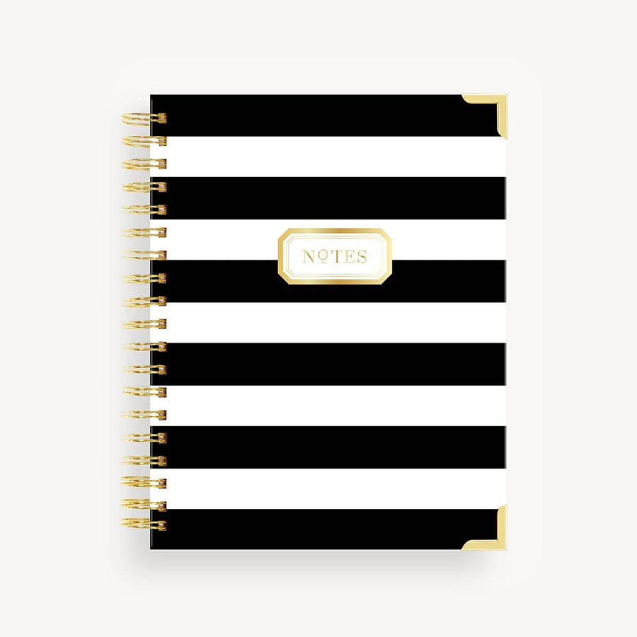 Black and white striped notebook with 'NOTES' label on a white background