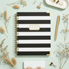 Black and white striped notebook with 'NOTES' label on a white background
