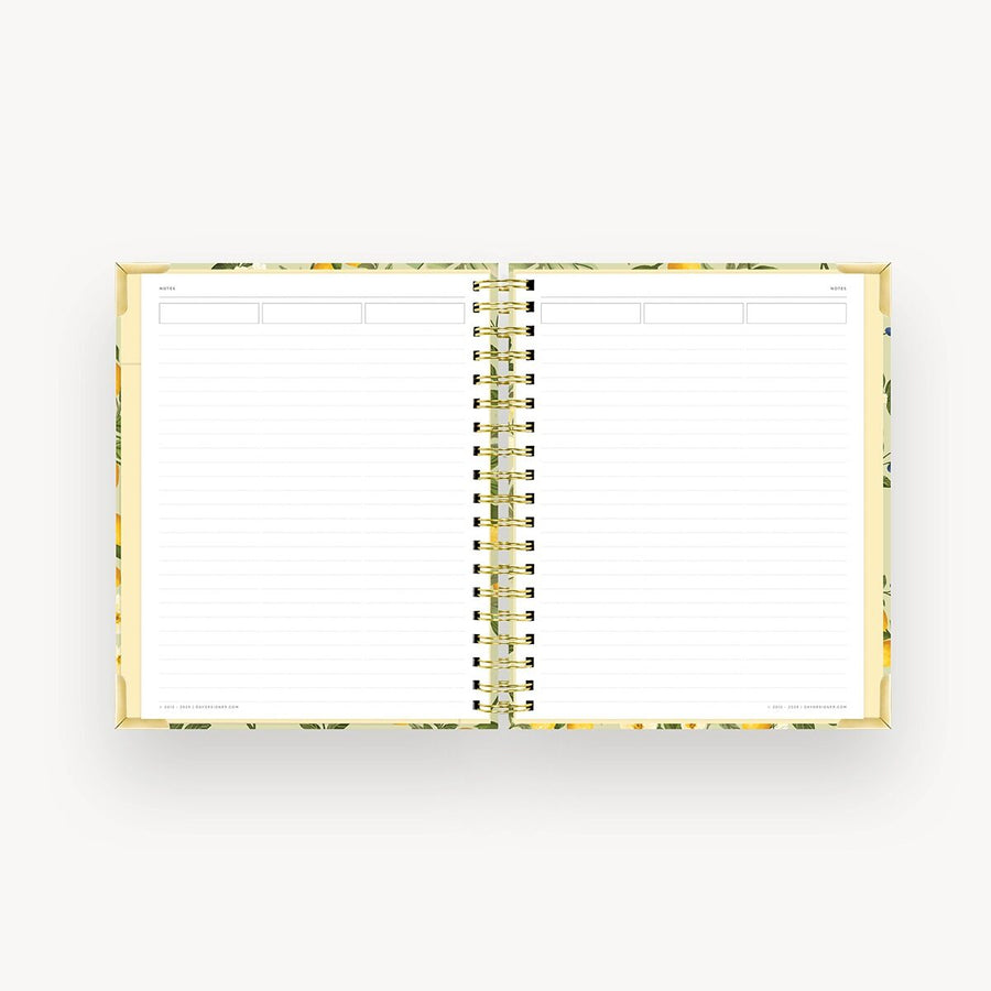 Open notebook with gold spiral binding on a white background