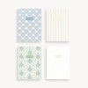 Four patterned notebooks with different designs on a white background