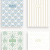 Four patterned notebooks with different designs on a white background