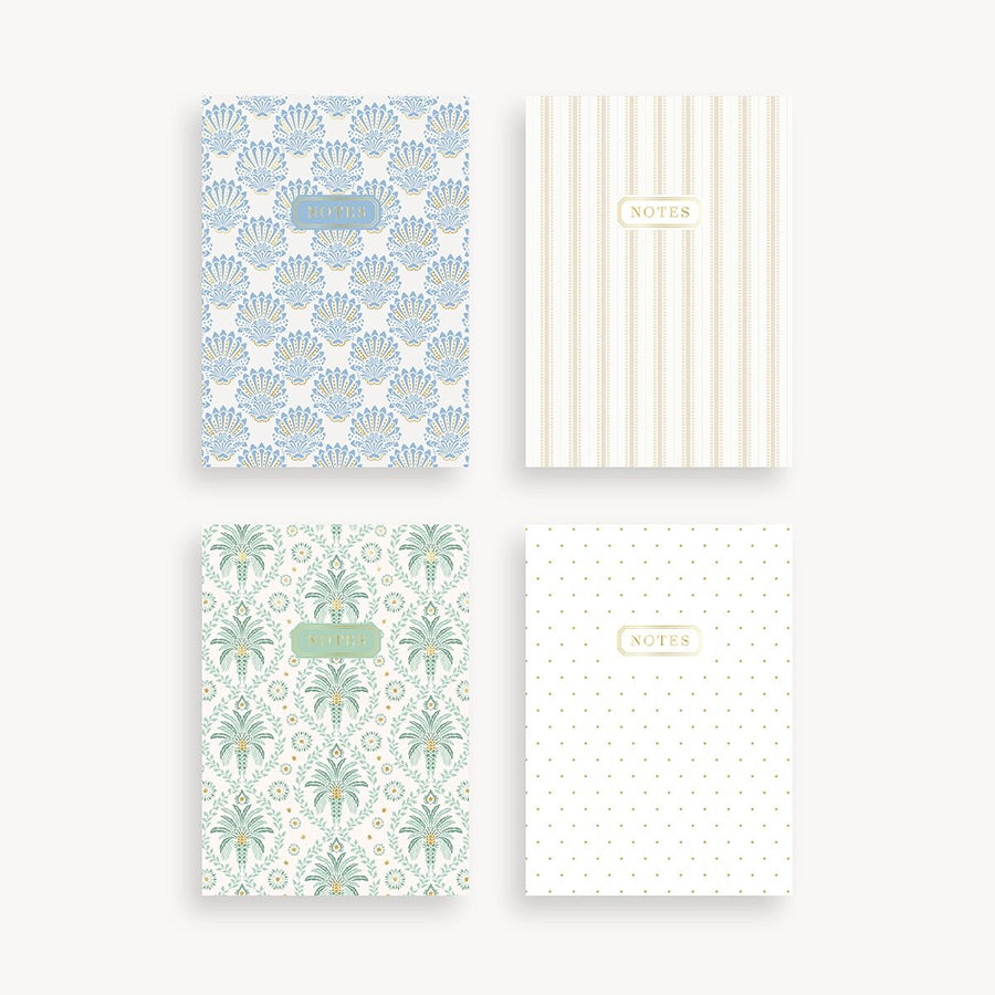 Four patterned notebooks with different designs on a white background