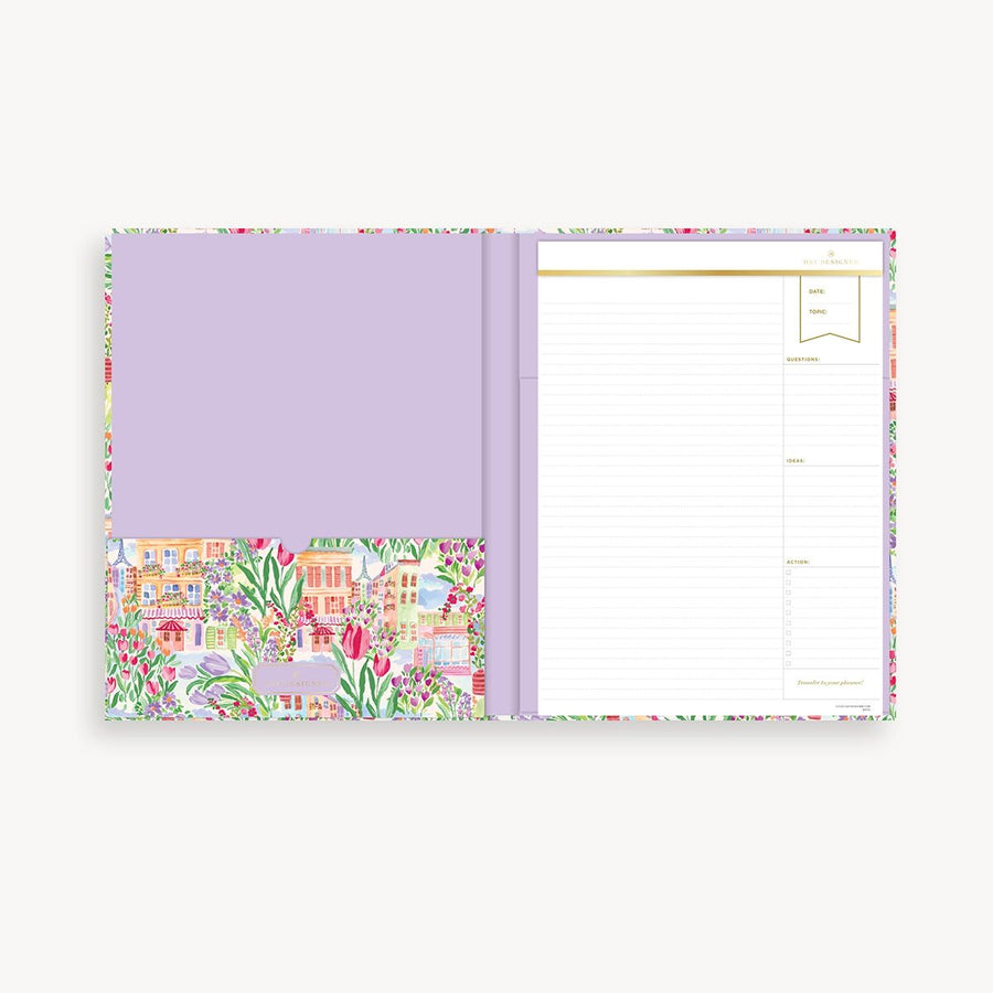 Purple planner with colorful floral design on a white background