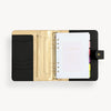 Open black A5 binder to show black and gold lining and binding, colorful pages