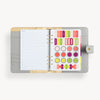 open gray A5 binder with notes pages, colorful stickers, snap closure and gold day designer logo