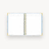 light blue mini notebook open to lined pages, gold binding