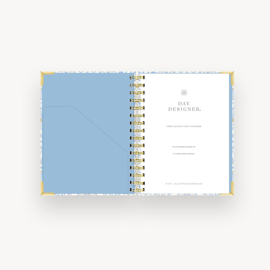 light blue and gold mini notebook open to light blue liner, day designer cover page