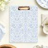 clipfolio with blue and gold block print pattern, beige background, plate, cloth, flowers, paper clip, basket, antique cup