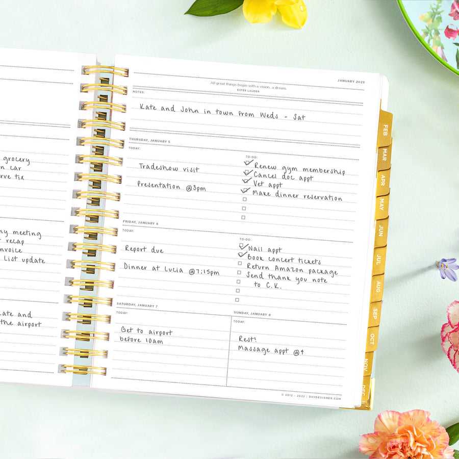 weekly planner, open book, written on pages, light mint background, multi-colored flowers, dish