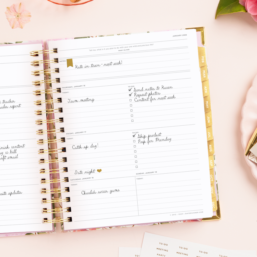 Day Designer 2025 weekly planner: Camellia opened with writing on it