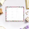 notepad with pink, red, and purple flowers, green leaves, lilac background, wood box, bell, fabric, flowers, dish, picture frame