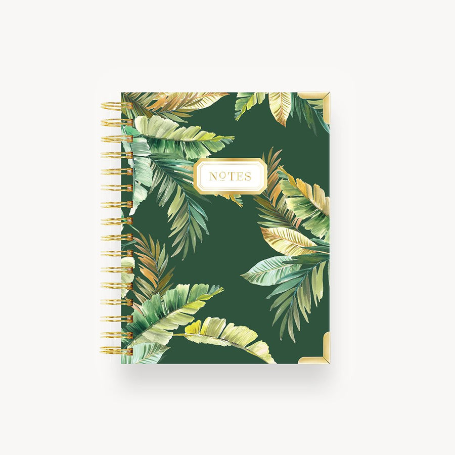 green and gold tropical leaves mini notebook on dark green background, gold binding and notes title