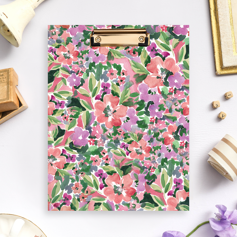 clipfolio with pink, red, and purple flowers, green leaves, lilac background, wood box, bell, fabric, flowers, dish, picture frame