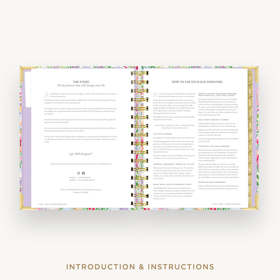 An open spiral-bound journal or planner showing printed introduction and instructions pages, with a pastel floral patterned cover and gold-toned binding, on a light neutral background.