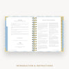An open spiral-bound booklet or planner showing printed introduction and instructions pages, centered on a light gray background with the text 'INTRODUCTION & INSTRUCTIONS' below.