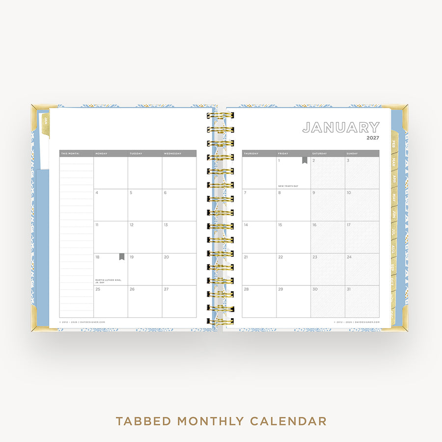 An open tabbed monthly calendar planner shown from above on a light gray background. The pages are white with gray grid lines and the word JANUARY 2027 at the top right.